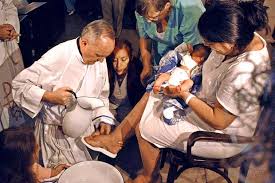 Archbishop Bergoglio washes a woman's feet